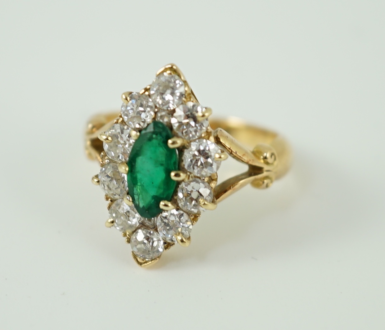 A Victorian style gold, emerald and diamond set marquise cluster shaped ring